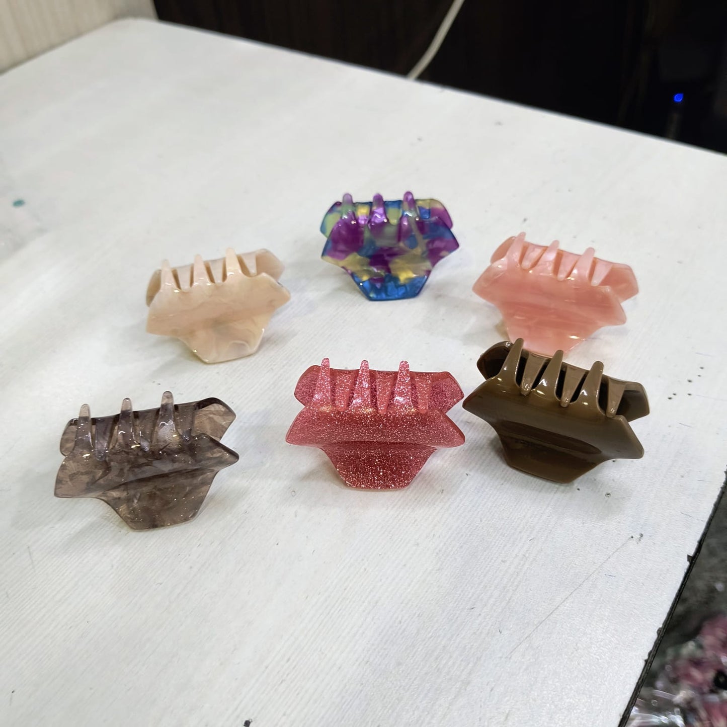 Gir Farmer small hair claw clips for women in assorted colors displayed on a white surface