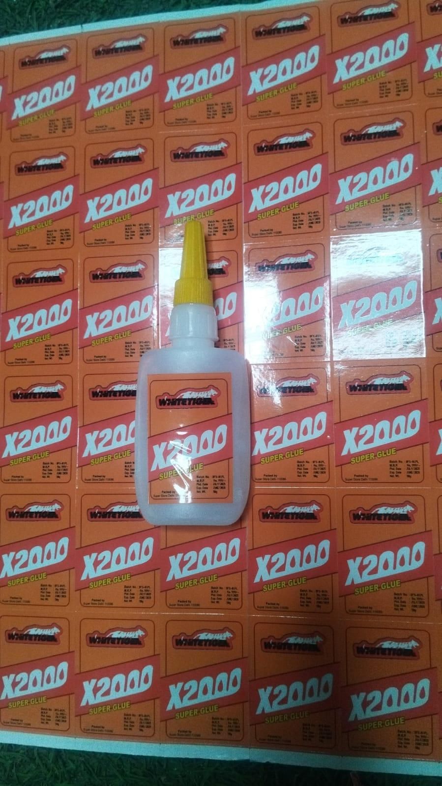 THE GIR FARMER X2000 strong adhesive for home repairs in a small white bottle with yellow cap on orange packaging sheets