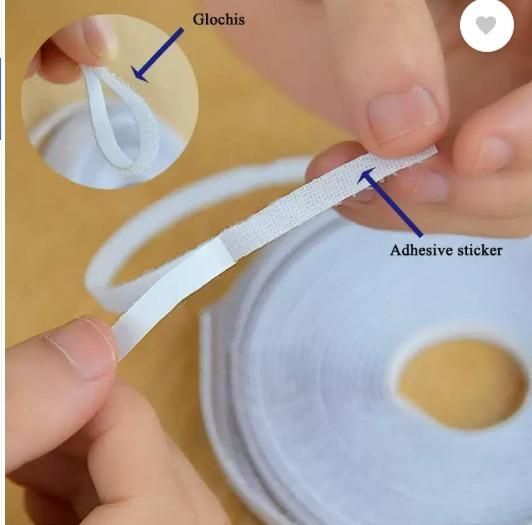 Close-up of hands peeling adhesive sticker from roll of window mosquito netting with labeled parts