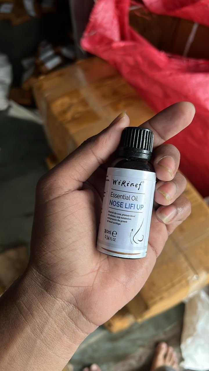 Bottle of 30ml nose lifting oil in hand for enhancing facial contour and lift