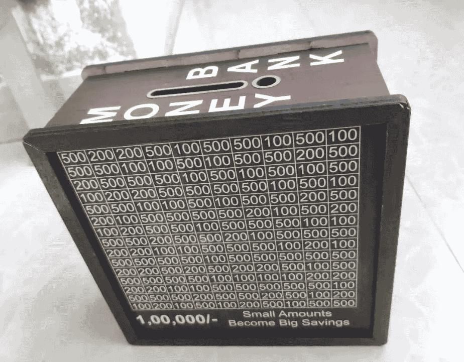 Wooden piggy bank for big savings with marked slots for different currency amounts
