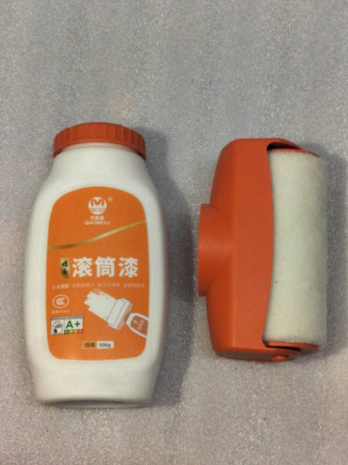 THE GIR FARMER wall facing roller paint bottle and orange handheld foam roller for smooth wall application
