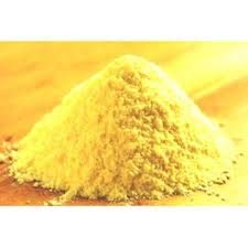 Pile of organic corn flour on a wooden surface for baking and cooking needs