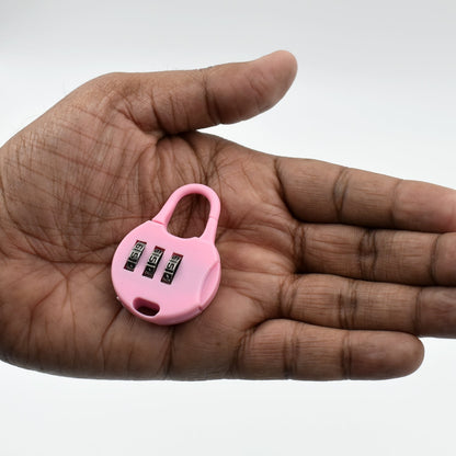 Pink 3 digit zipper lock in hand for easy and secure closure of bags and luggage