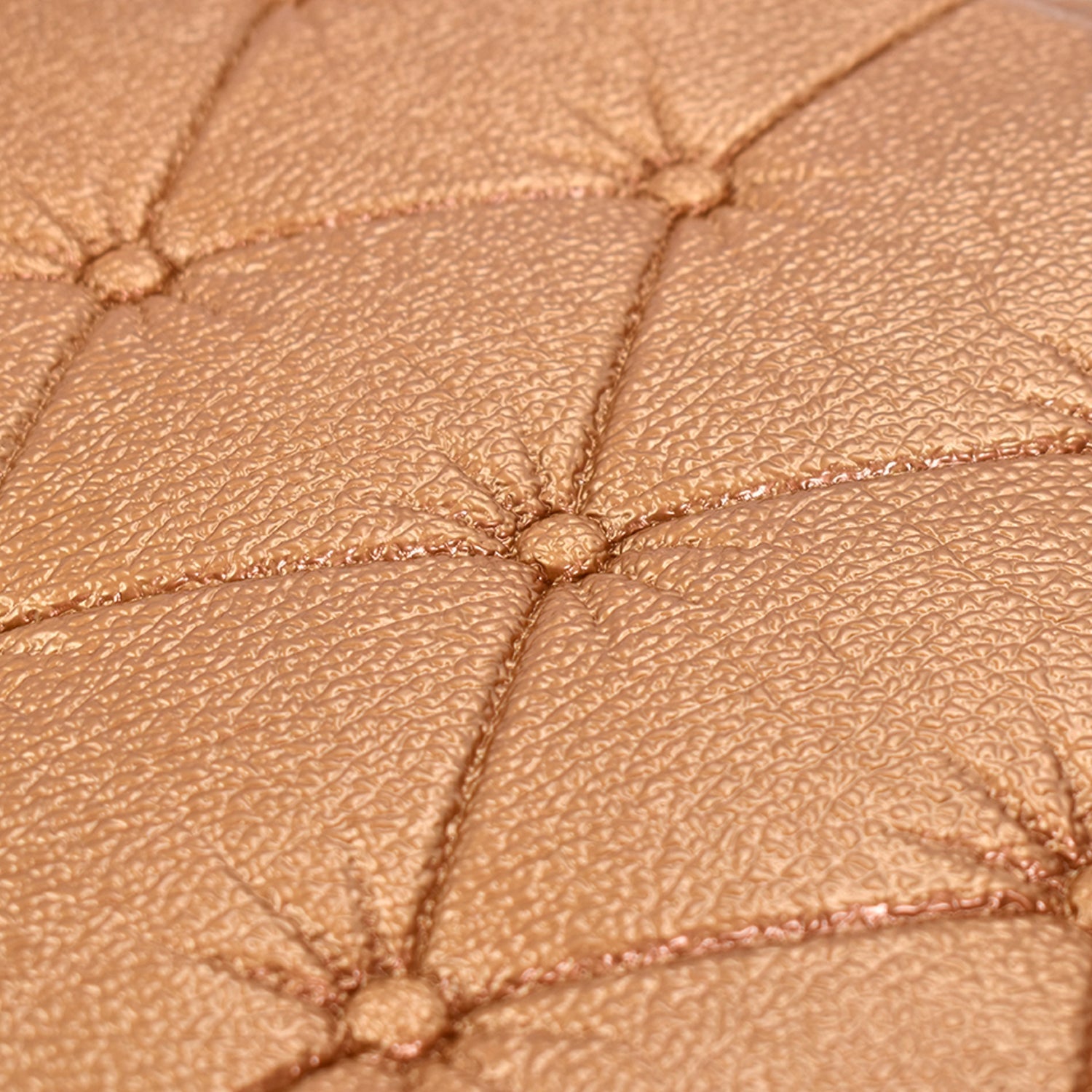 Close-up of textured 3D adhesive wallpaper in a warm gold color for home decor