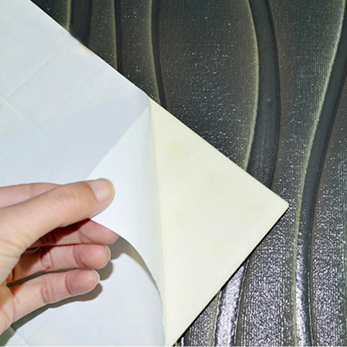 Installing 3D foam wallpaper panels with a textured surface for modern home decor