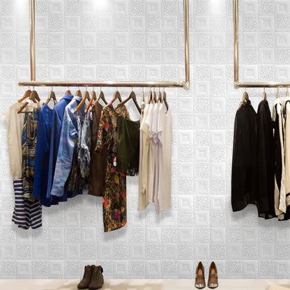 Stylish 3D foam wallpaper panels in a boutique with clothing display and shoes on the floor