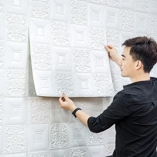 Installing 3D foam wallpaper panels on a white wall for a modern home improvement look.