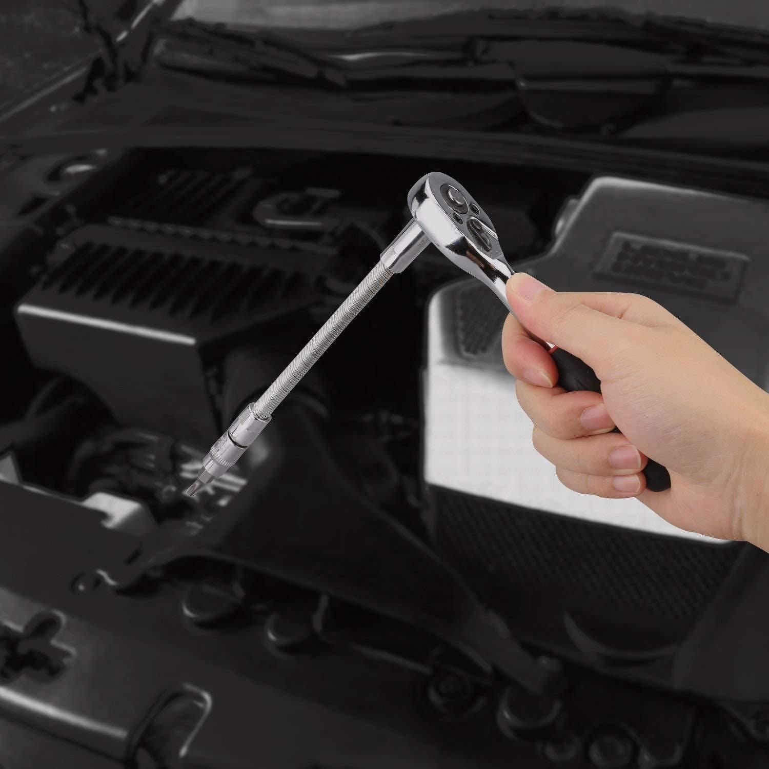 Hand using a ratchet from a 46 in 1 socket tool kit on an engine for efficient repairs