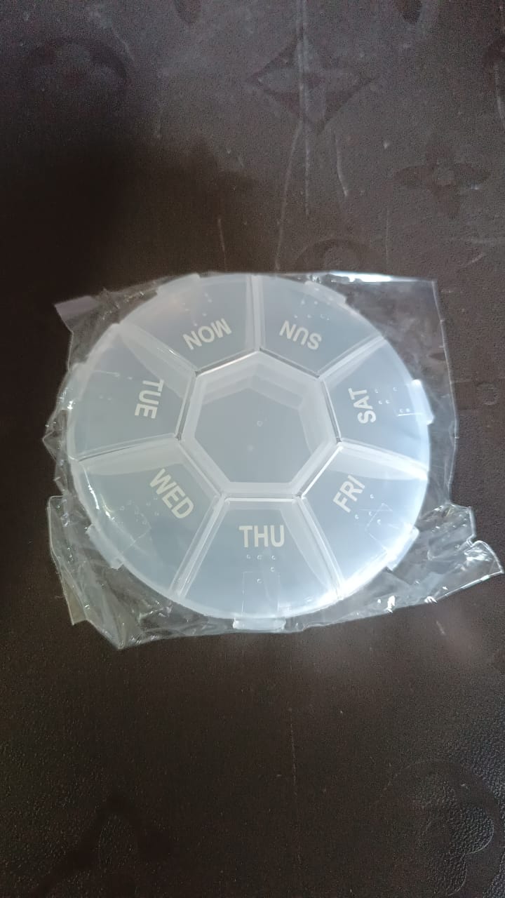 Clear plastic 7 day pill organizer with daily compartments for easy medication management