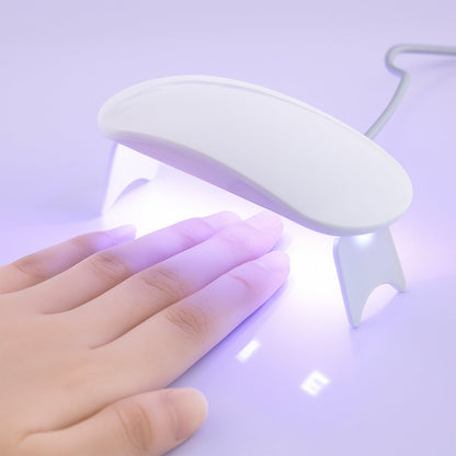 Compact mini UV nail lamp for gel polish with gentle light for quick drying