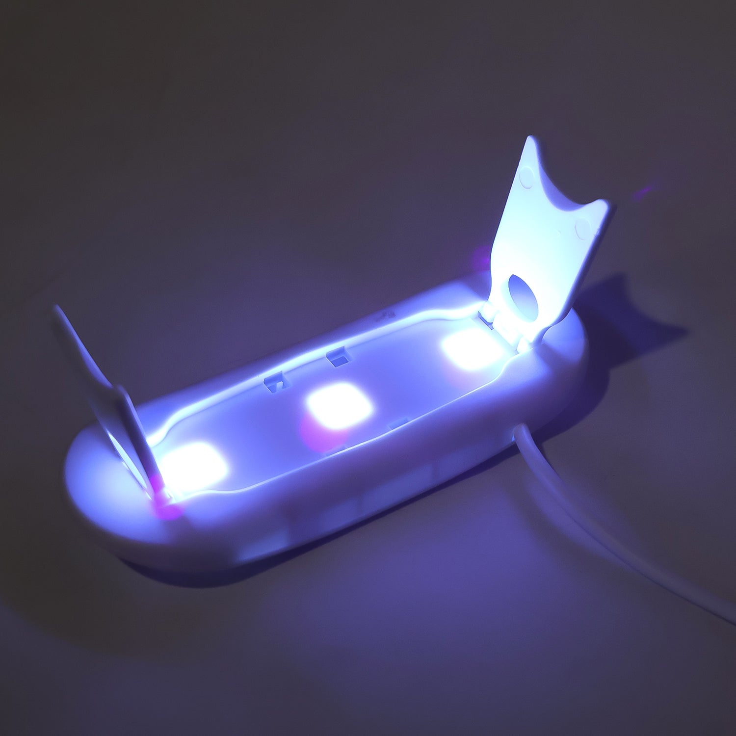 Compact mini UV nail lamp for gel polish with dual light source for efficient curing.