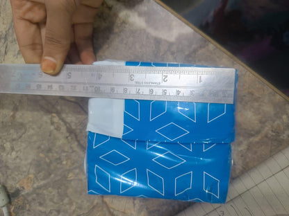 Blue adhesive fabric fusion tape with measurement ruler for precise cutting and application