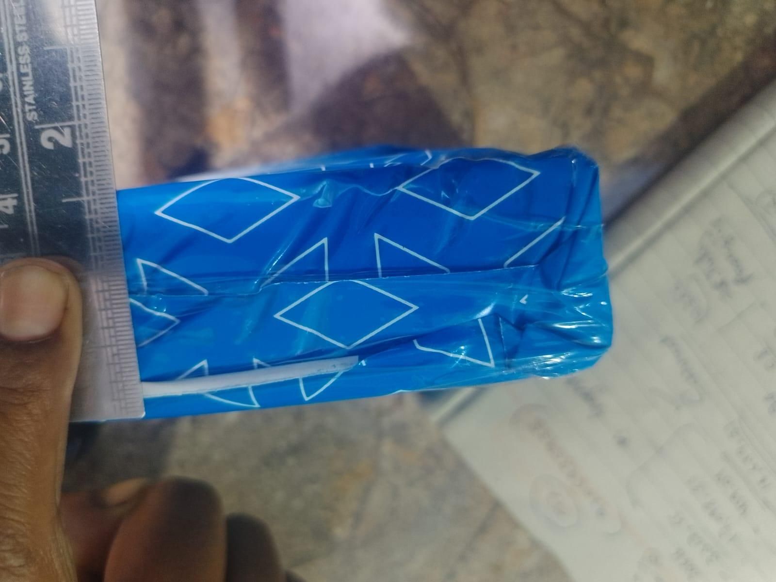 Close-up of adhesive fabric fusion tape in blue packaging for easy fabric repairs