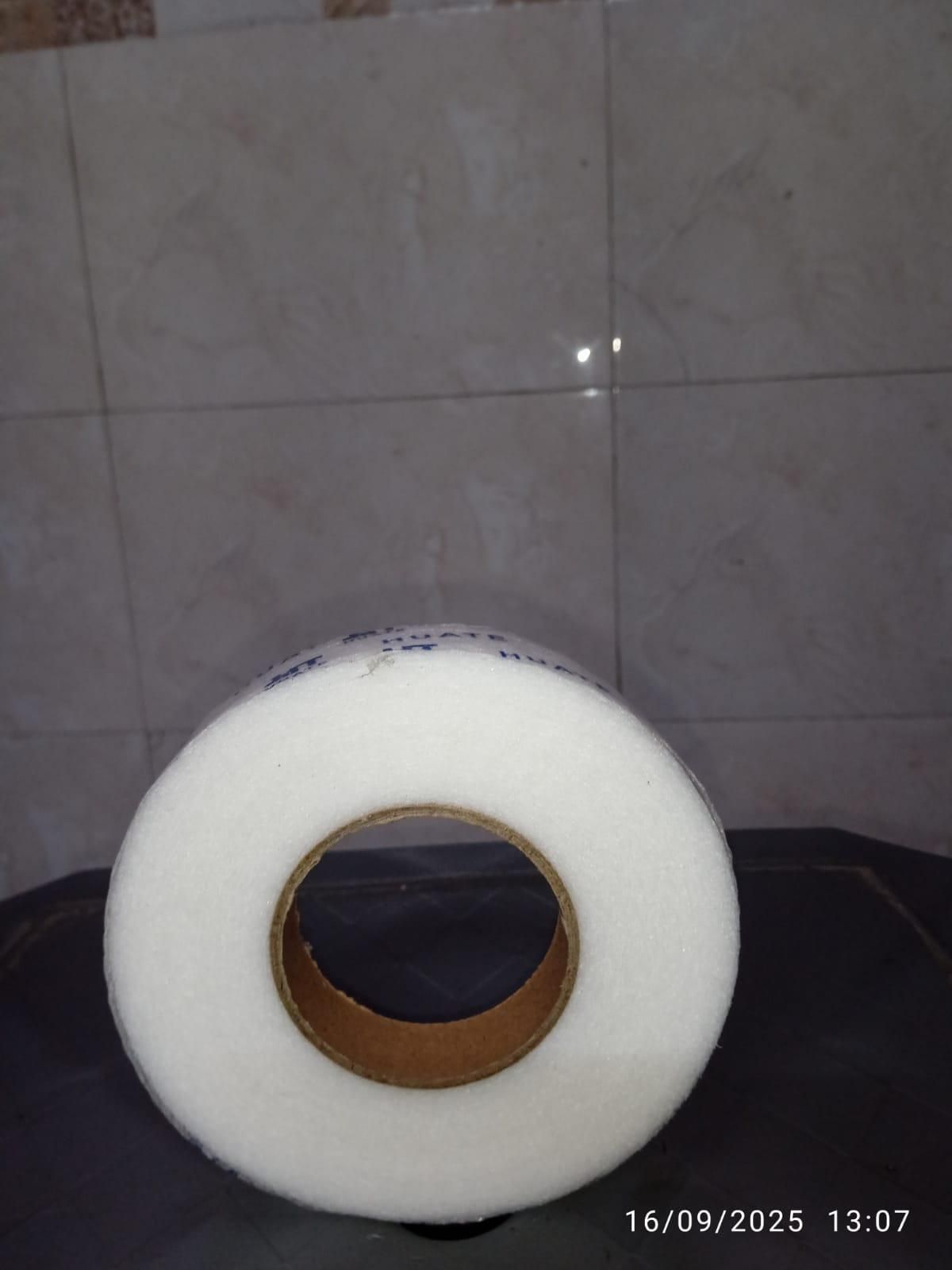 Roll of adhesive fabric fusion tape for seamless fabric bonding and crafting projects