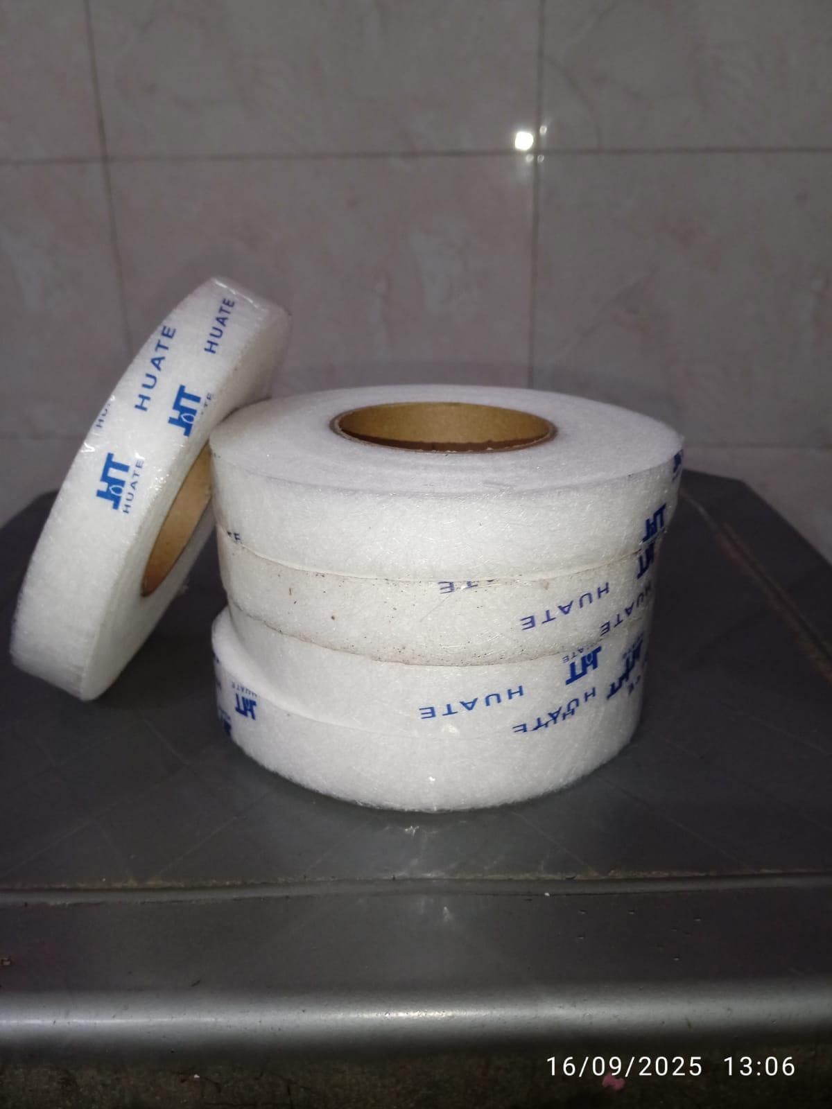 Rolls of adhesive fabric fusion tape stacked neatly for crafting and sewing projects