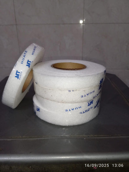 Rolls of adhesive fabric fusion tape stacked neatly for crafting and sewing projects