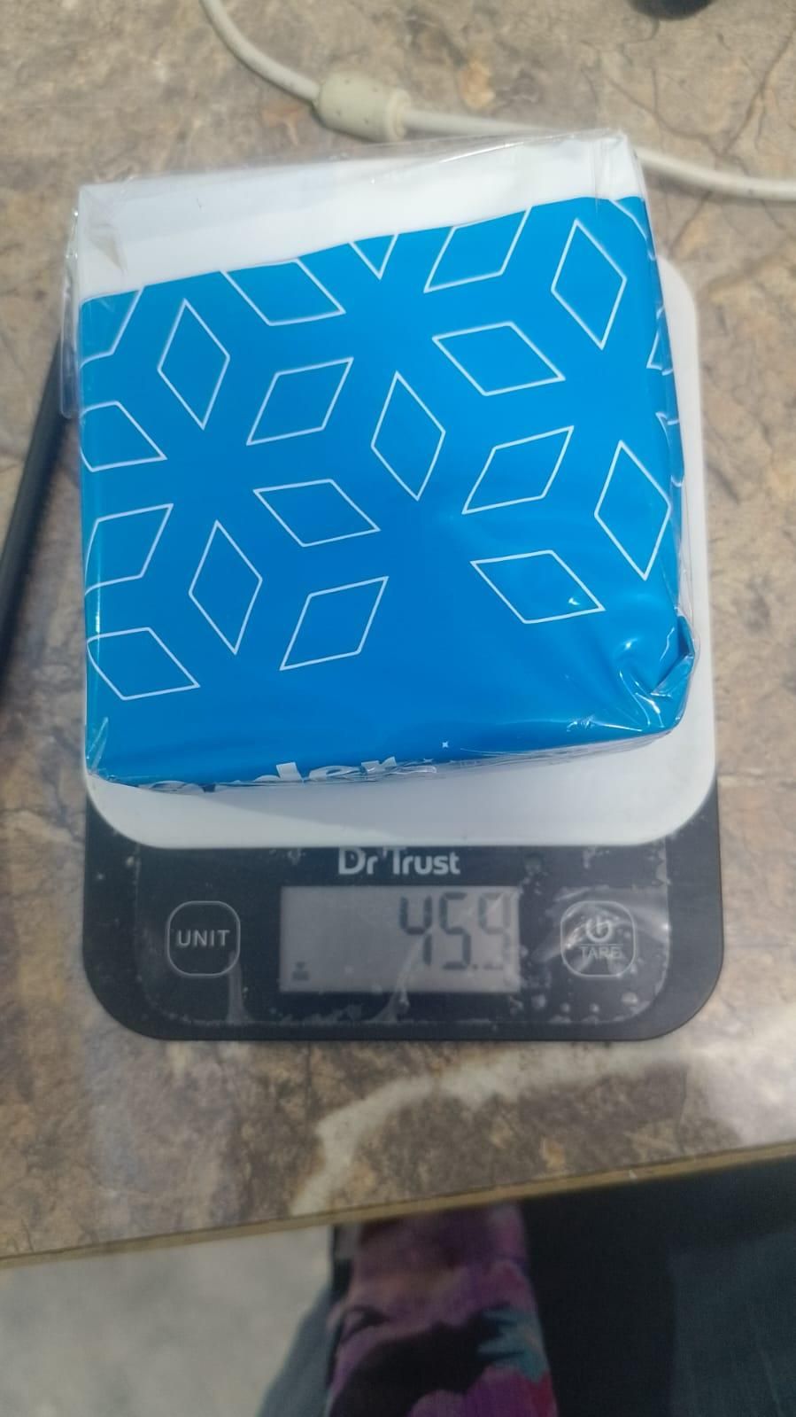 Adhesive fabric fusion tape package weighing 459 grams on a digital scale