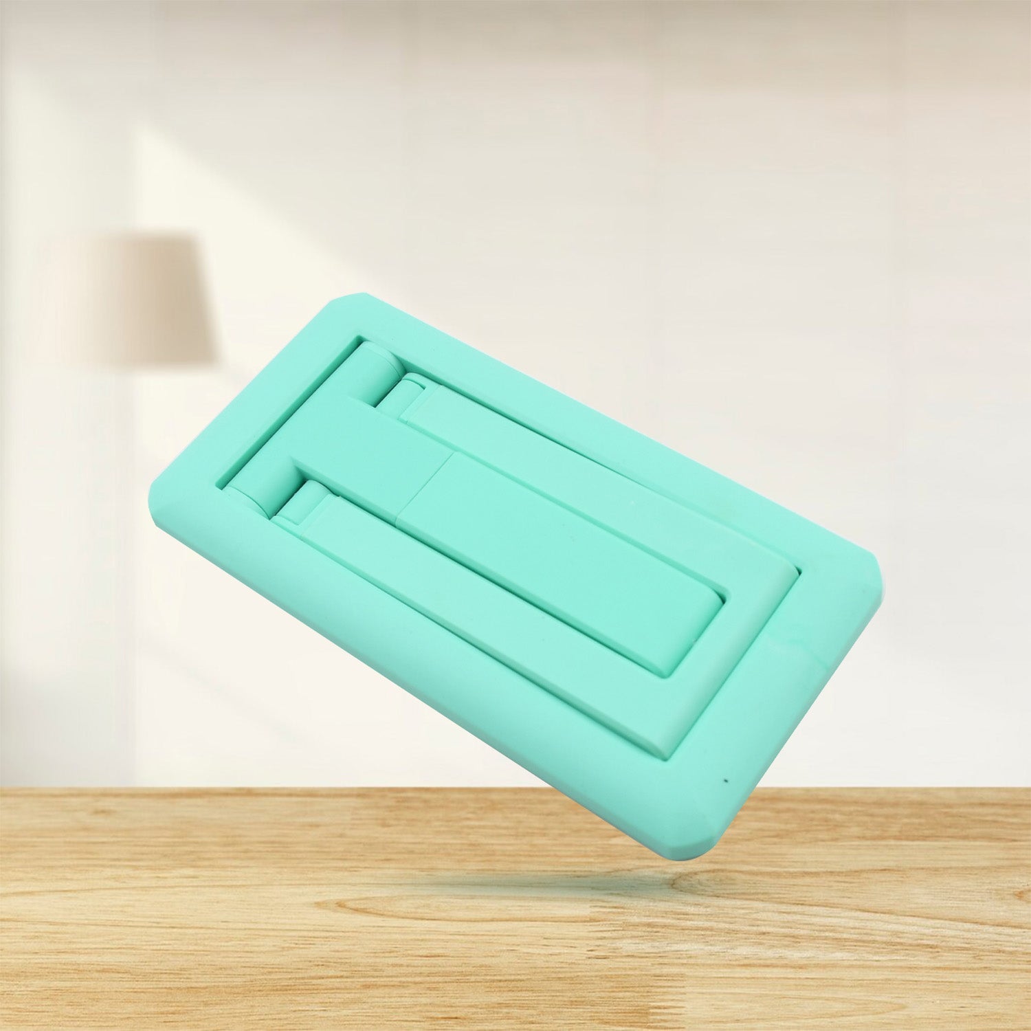 Adjustable foldable mobile stand in mint green for convenient phone viewing and hands-free use