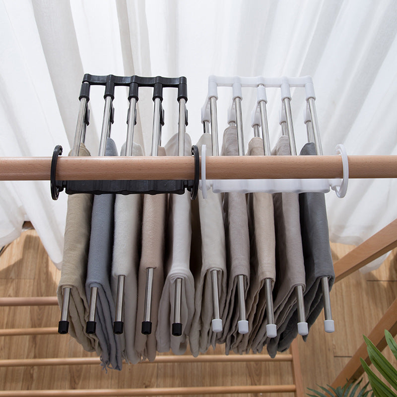 Adjustable trouser hanger organizer holding multiple pairs of pants in a closet for easy access