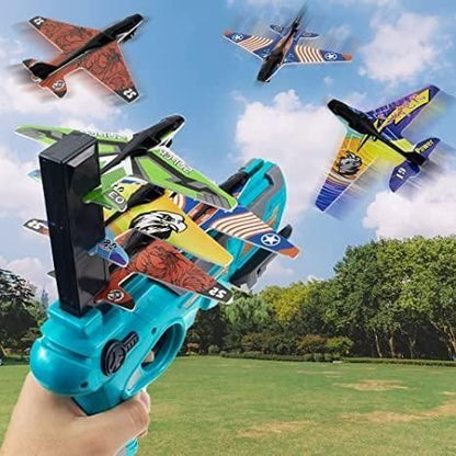 Colorful airplane launcher toy gun with multiple planes soaring in the sky over a grassy field