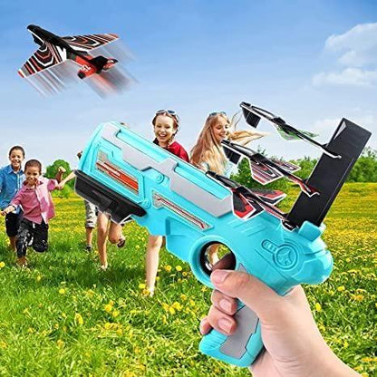 Colorful airplane launcher toy gun for outdoor play with kids running and flying planes in the background