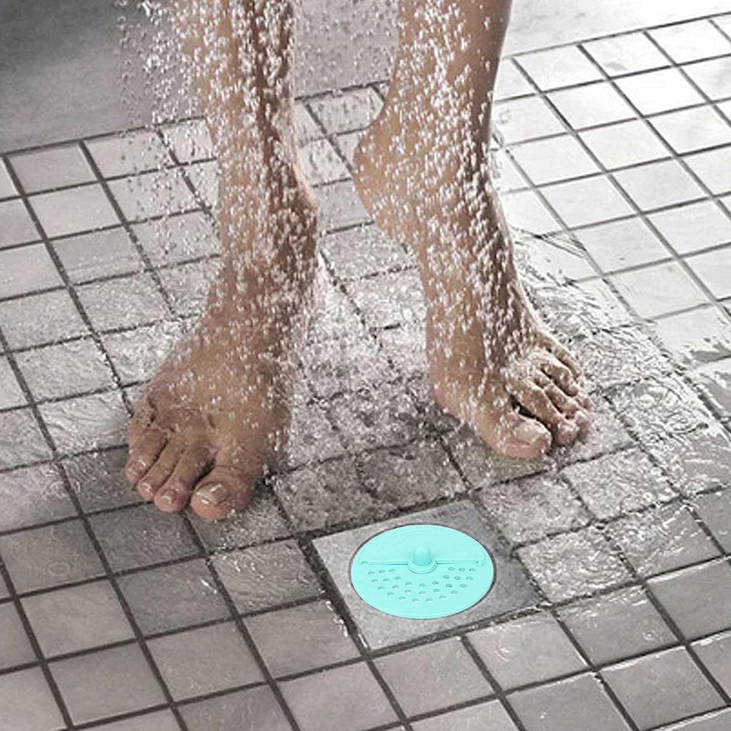 Anti-odor round drain cover in a shower, blocking hair and odors while allowing water flow