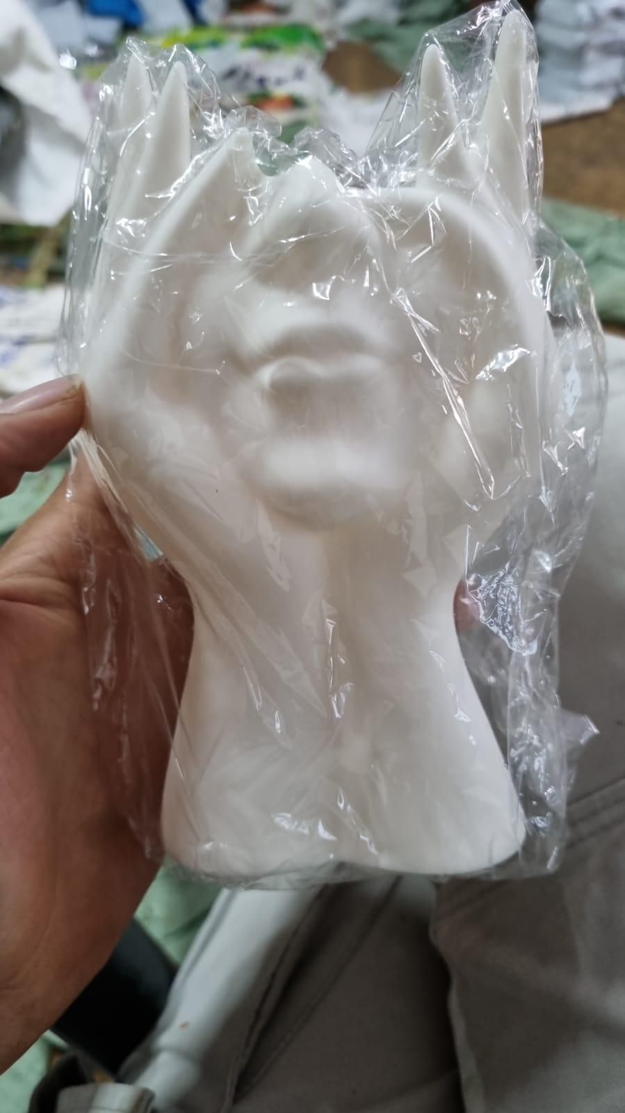 Artistic hand face vase for home decor made of white ceramic with a unique design