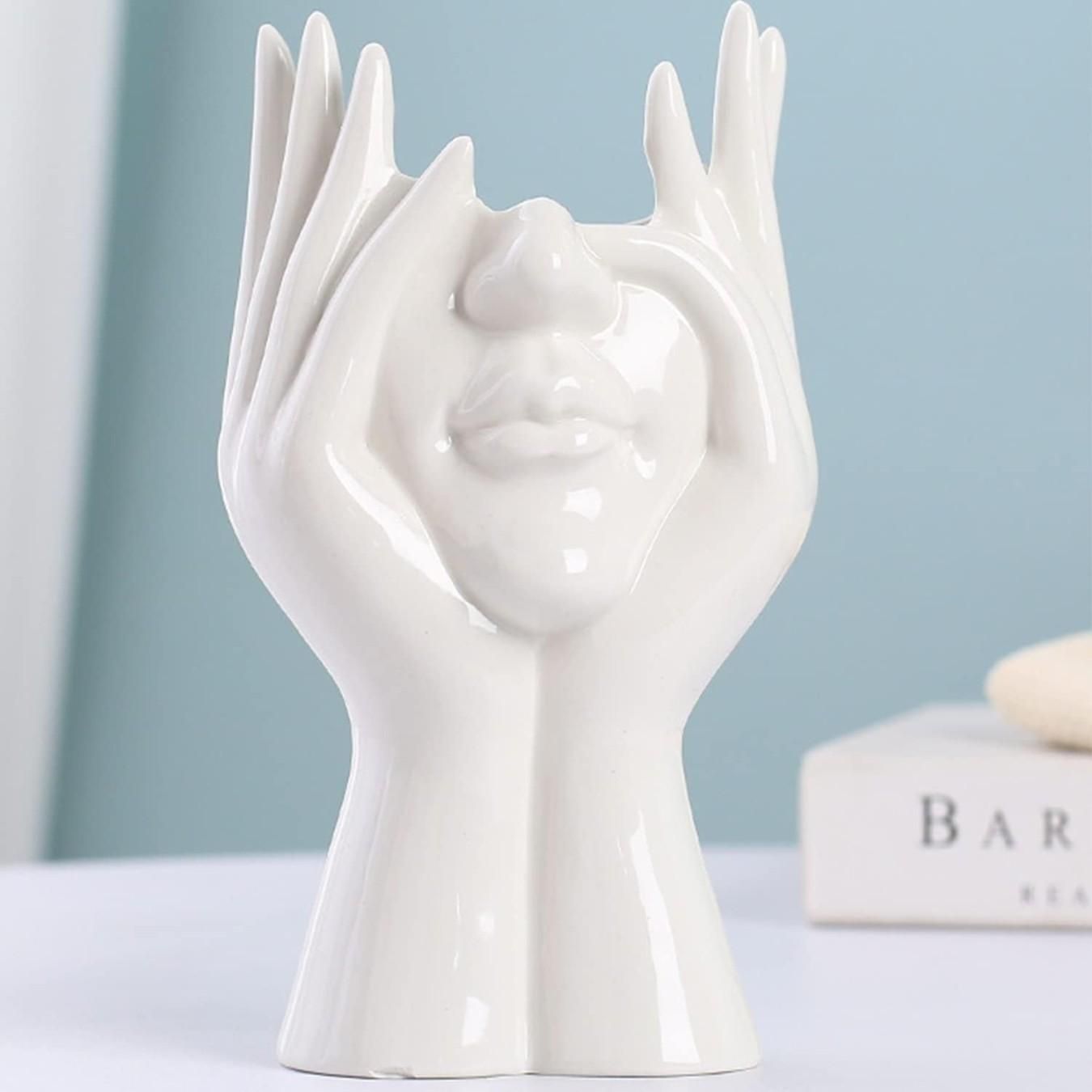 Artistic hand face vase for home decor, featuring a unique design with hands forming a face