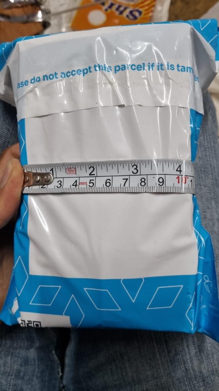 Parcel being measured with a tape measure for delivery of an artistic hand face vase for home decor
