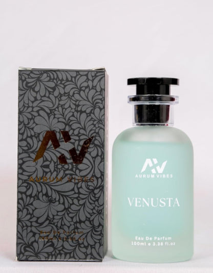 Venusta perfume 100ml bottle with frosted glass and black cap next to decorative black and gray floral patterned box
