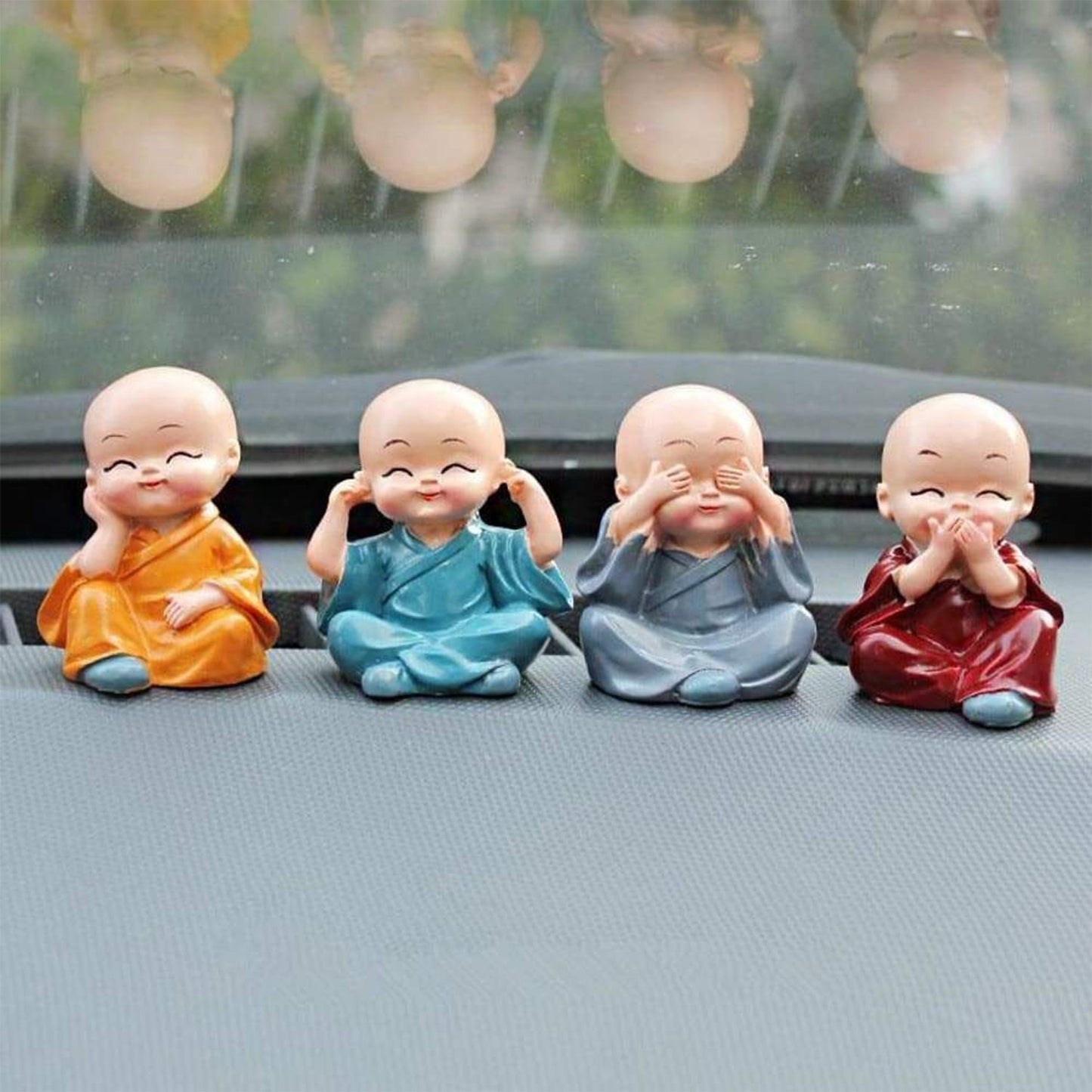 Baby Buddha showpiece set featuring four colorful laughing figures for home decoration