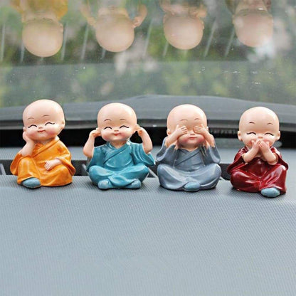Baby Buddha showpiece set featuring four colorful laughing figures for home decoration