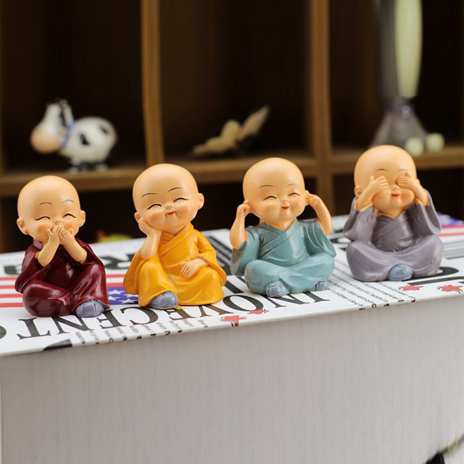 Baby Buddha showpiece set featuring four cheerful monk figurines in colorful robes for home decor