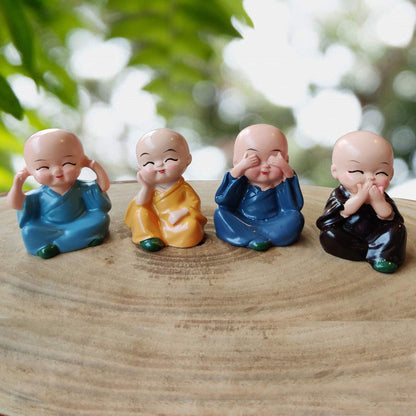 Cute baby buddha showpiece set featuring four colorful figurines expressing joy and tranquility