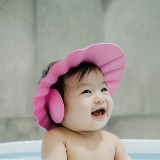 Pink baby shower cap splash proof designed to keep water away from baby's face during bath time