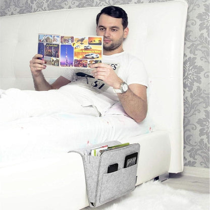 THE GIR FARMER bedside pocket organizer for essentials attached to white bed holding phone and magazines