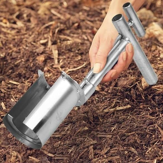 Hand holding the best tool for repotting plants with a metal scoop and ergonomic handle in soil