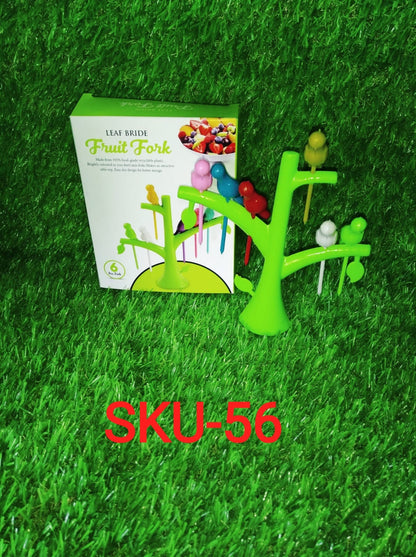 Colorful bird fruit fork for kids displayed on a green grassy background with packaging