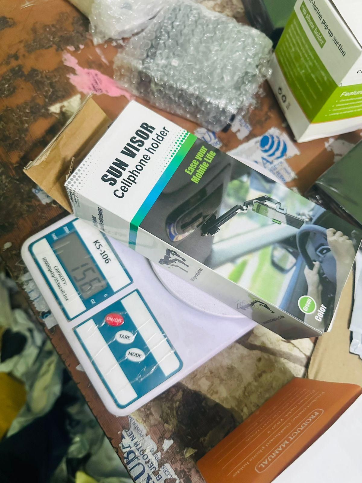 Sun Visor car cellphone holder packaged on a workspace ready for installation in vehicles