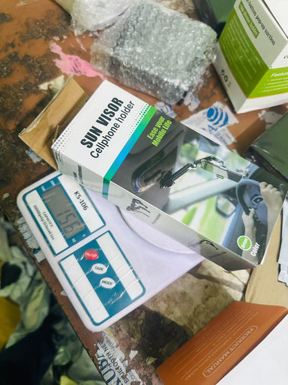 Sun Visor car cellphone holder packaged on a workspace ready for installation in vehicles