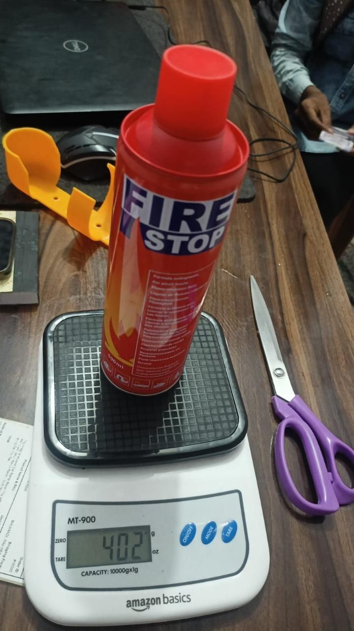Car fire extinguisher spray on a digital scale for easy measurement and safety readiness