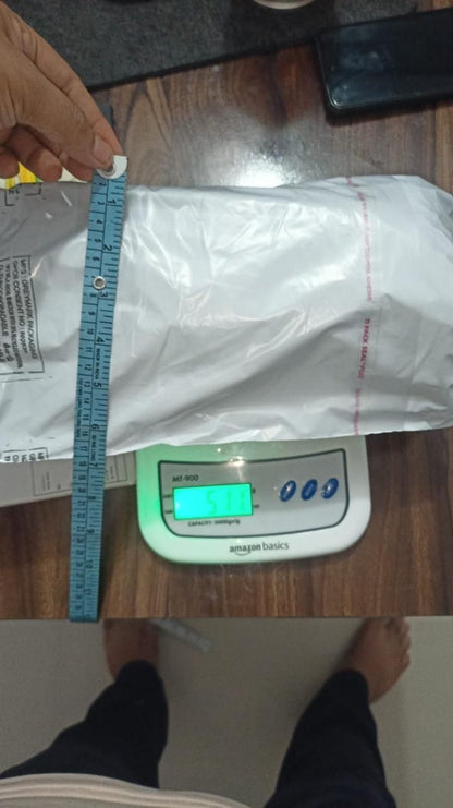 Packaging of a car fire extinguisher spray being measured with a ruler on a digital scale