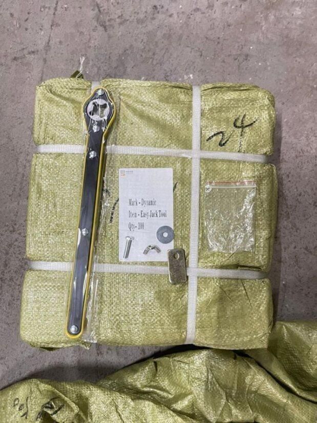 Compact car jack and lug wrench set packaged with protective wrapping for easy storage and transport