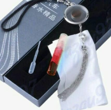 Car logo perfume pendant in silver with colorful fragrance vial and tassel detail