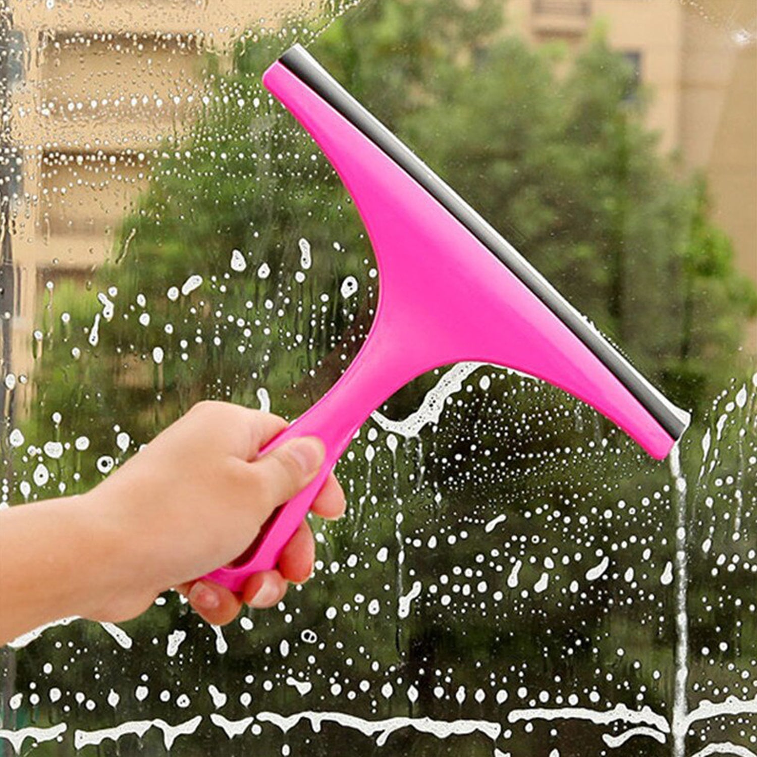 Hand holding a pink car mirror wiper for cleaning and drying surfaces efficiently