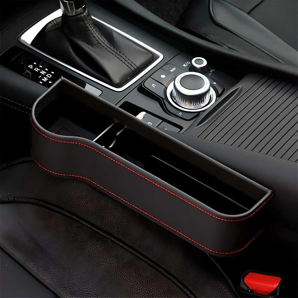 Car seat gap organizer in black leather with red stitching for convenient storage and organization