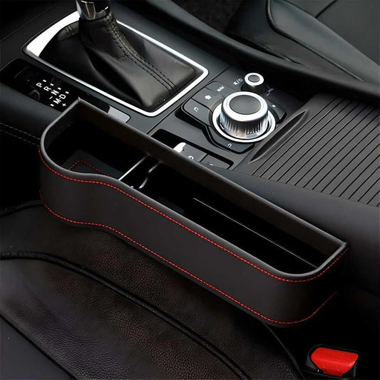 Car seat gap organizer in black leather with red stitching for convenient storage and organization