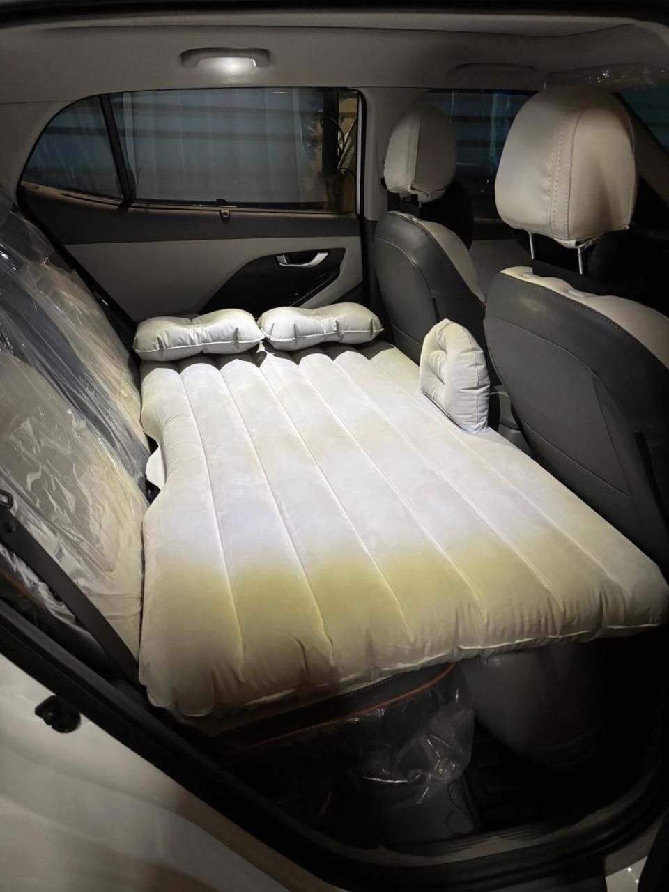 Car travel air mattress designed for comfortable sleeping in vehicles with adjustable support pillows