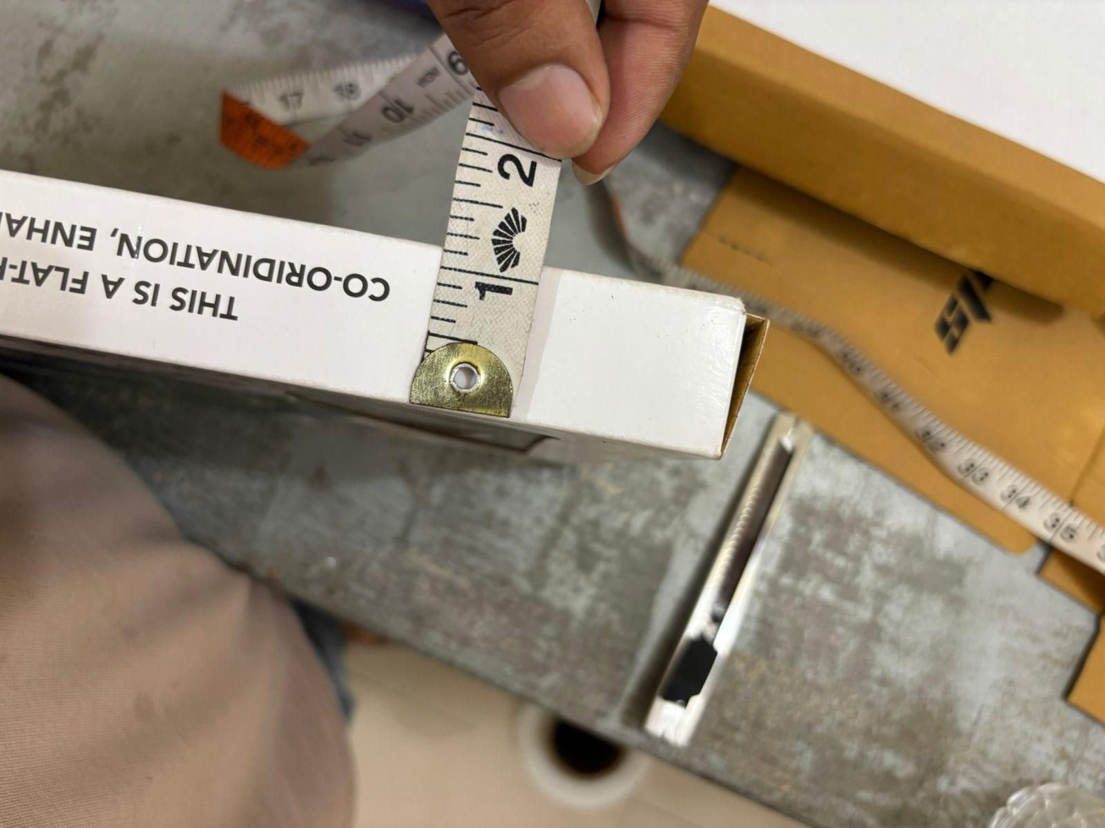 Measuring the box of a catapult board game for kids showing its dimensions for accurate sizing